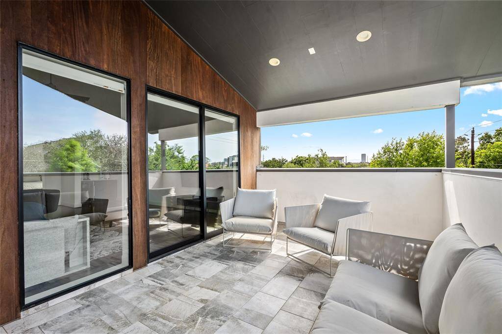 Through the sliding glass door, step outside to the third floor balcony.