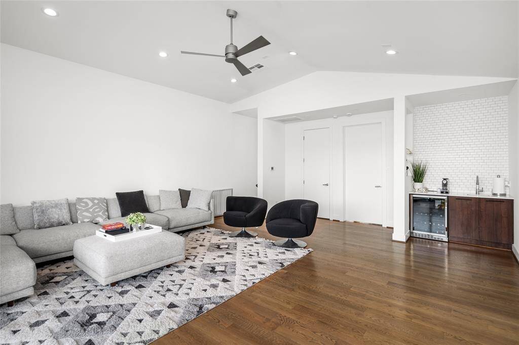 A wet bar and beverage refrigerator are conveniently situated on the opposite side of the game room. Through the door on the left, you’ll find the final full bathroom, while the fourth secondary bedroom is located to the right.