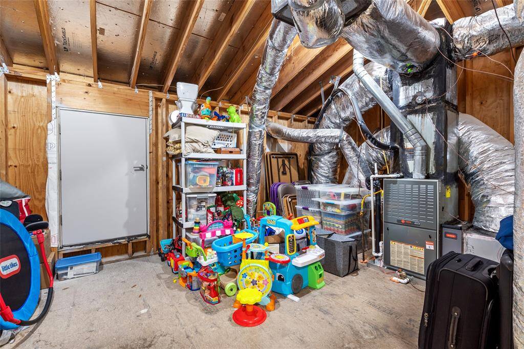 This attic storage space can be reached through the large closet. This is an incredible bonus! HVAC is very accessible in the attic w/ condenser located just past the door ahead.