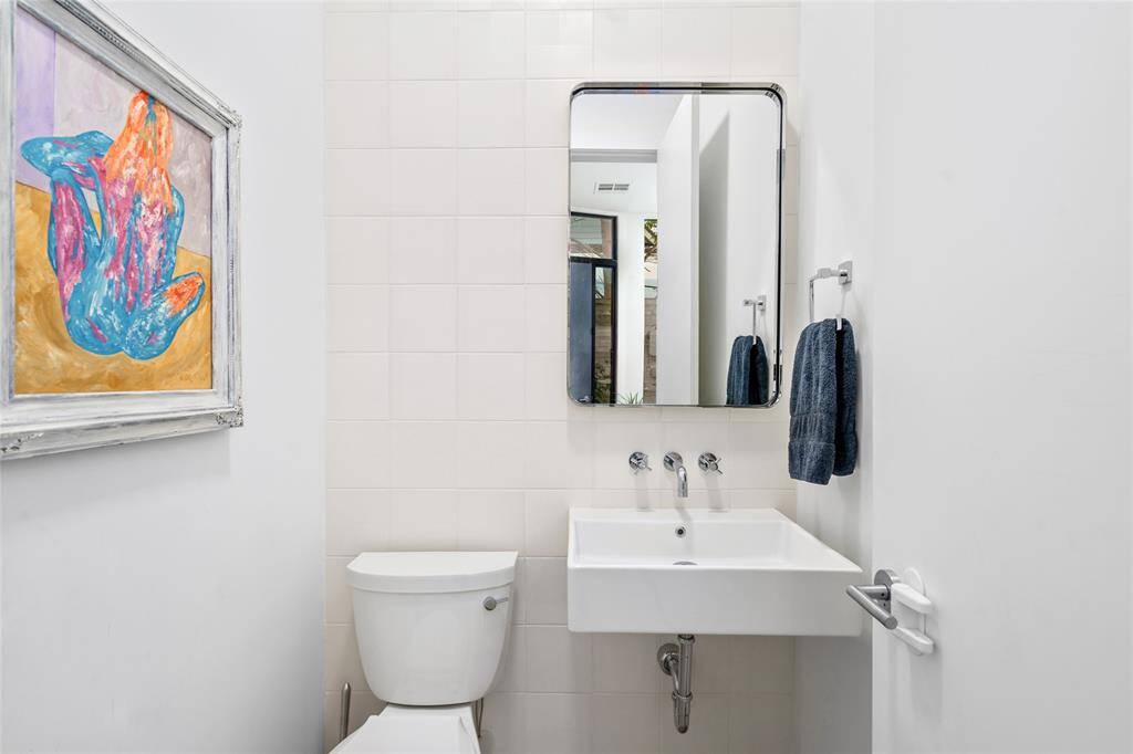 Bright half bath located on the first floor, by the front door.