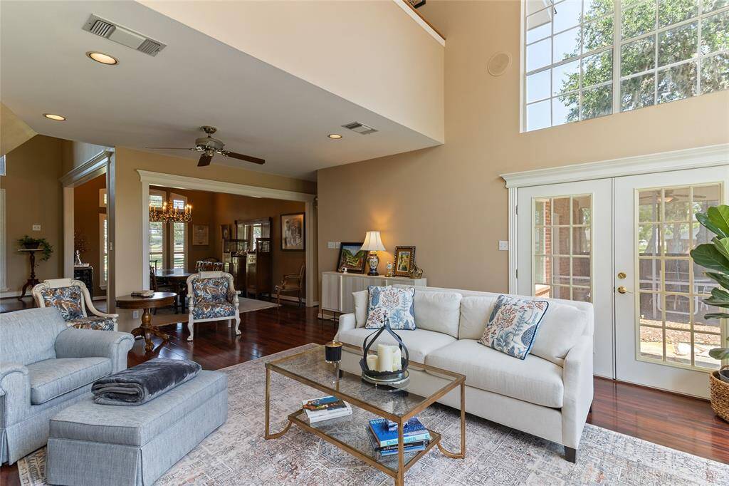 Warm & welcoming family room (24x19) offers French door access to the serene courtyard & newly added covered back porch—seamlessly extending your living space outdoors for effortless entertaining & everyday enjoyment.