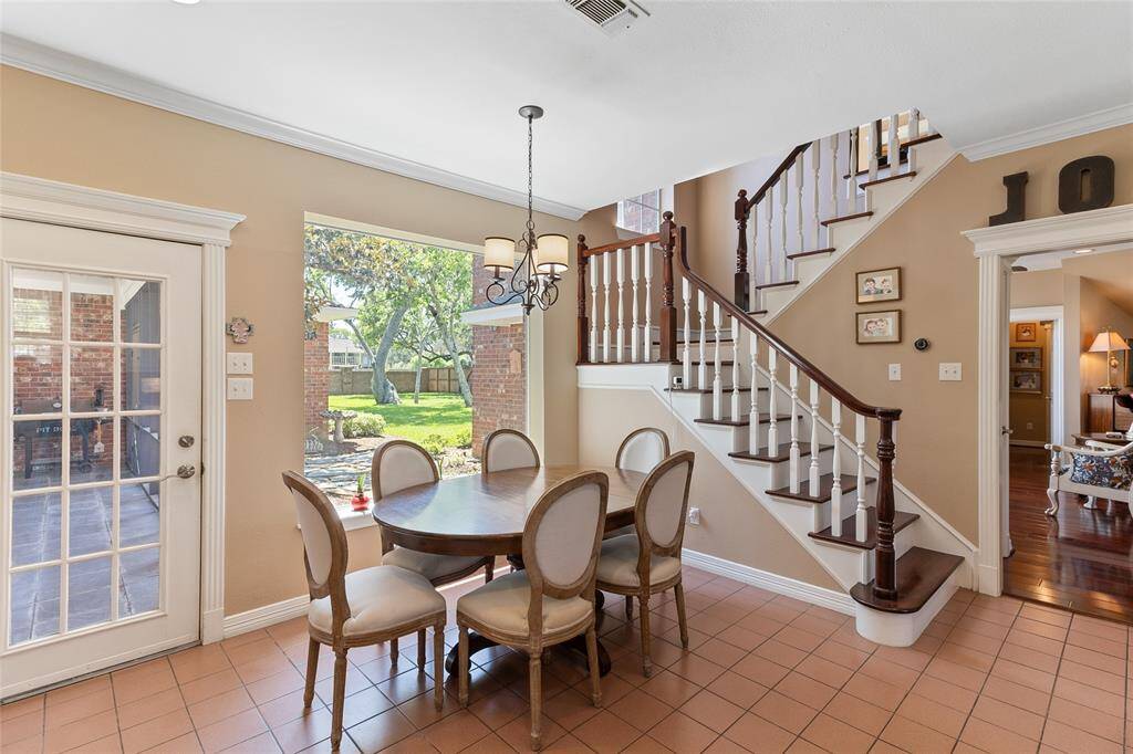 Enjoy peaceful backyard views from the breakfast nook (11x8) which seamlessly connects to the expansive family room & offers views into the private primary bedroom wing—creating a functional & inviting flow throughout the main level.