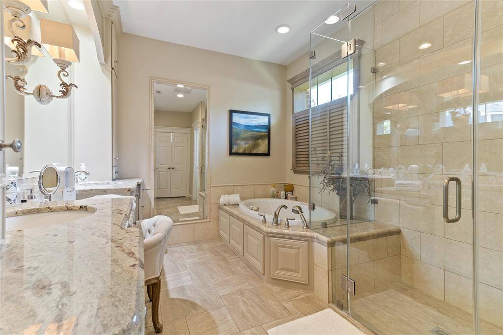 Luxurious spa-inspired en-suite bath that was beautifully remodeled in 2014 with timeless & elegant finishes highlighted by the soft recessed lighting & natural light from the privacy window—truly enhancing the tranquil ambiance.