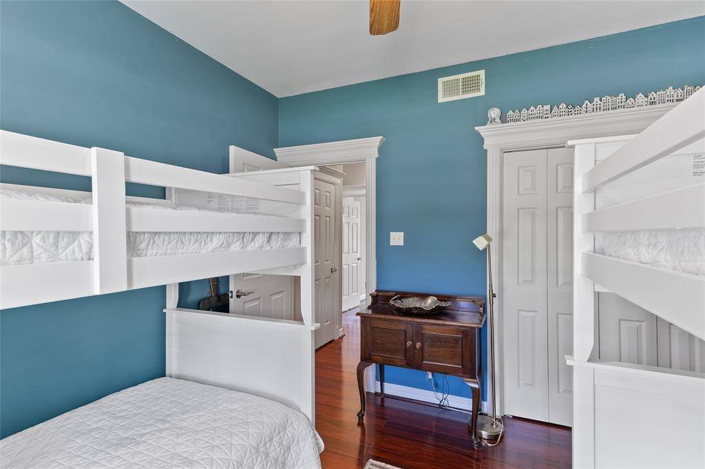 This downstairs bedroom offers a full closet and convenient access to an adjacent full hallway bathroom, making it a versatile space to suit your needs.