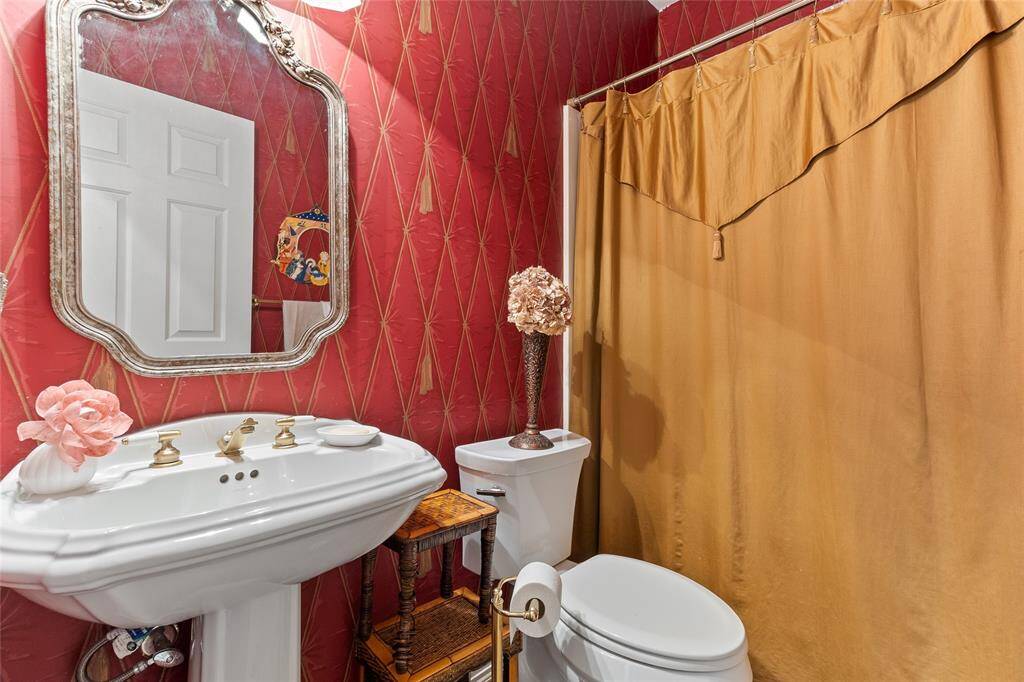 Stylishly updated full bathroom is conveniently located downstairs, making it ideal for guests or as an en-suite option for Bedroom #2—combining charm with everyday functionality.