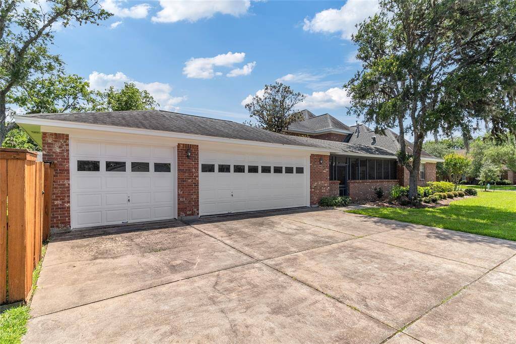 Enjoy the convenience of an oversized 3-car garage, seamlessly connected to the home by a covered & fully screened-in porch—offering both sheltered access & additional space to relax or entertain.