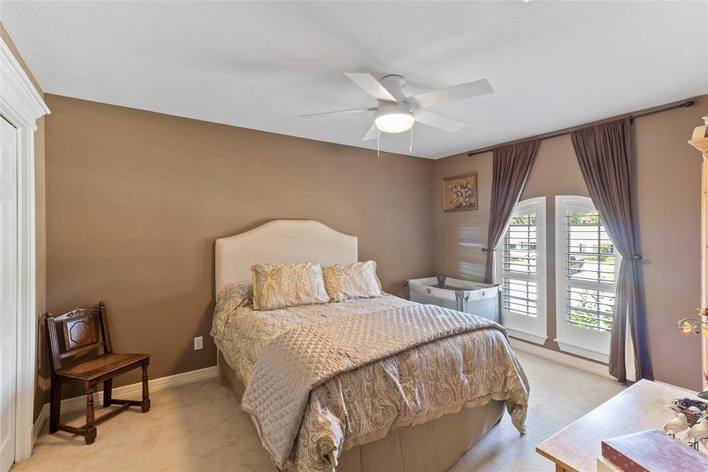 Bedroom #4 offers a spacious layout (17x14) & overlooks the front of the home. Plantation shutters add a classic touch while offering light control & privacy—making this space ideal for a guest suite, teen room, or private retreat.