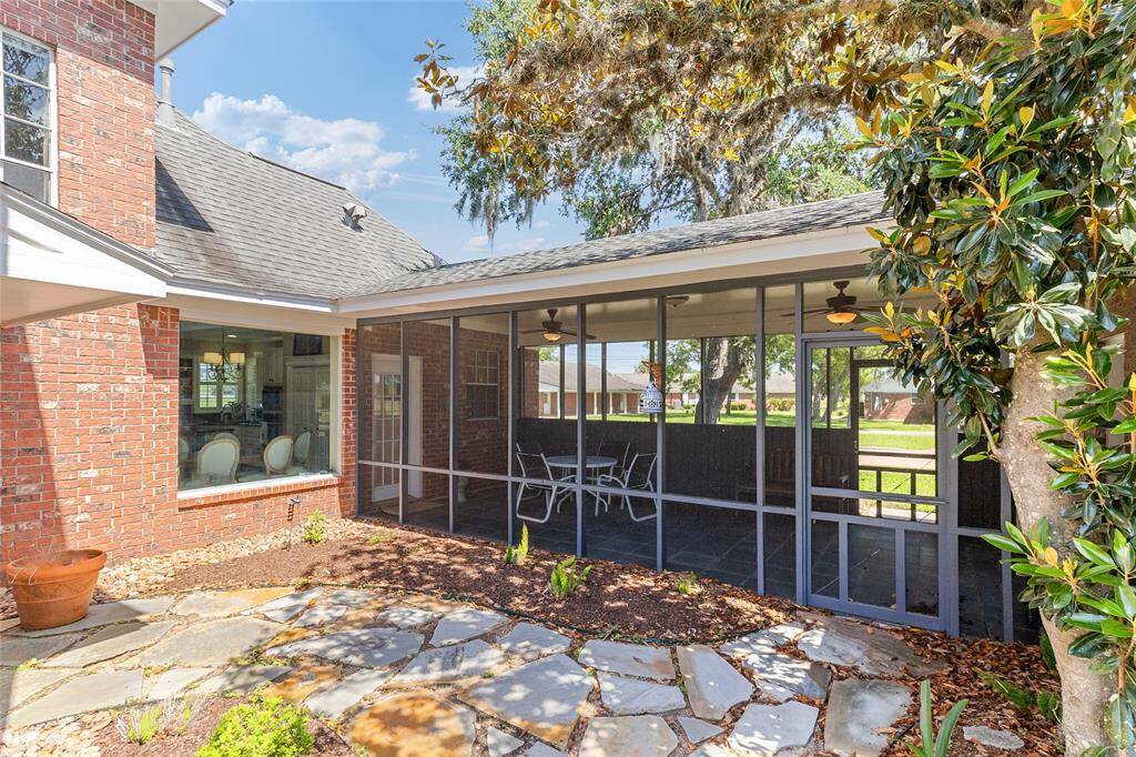 Inviting view of the screened-in patio also highlights a key upgrade—pipes running from the home to the garage were replaced with durable PERT piping in 2021, ensuring long-lasting performance & peace of mind.