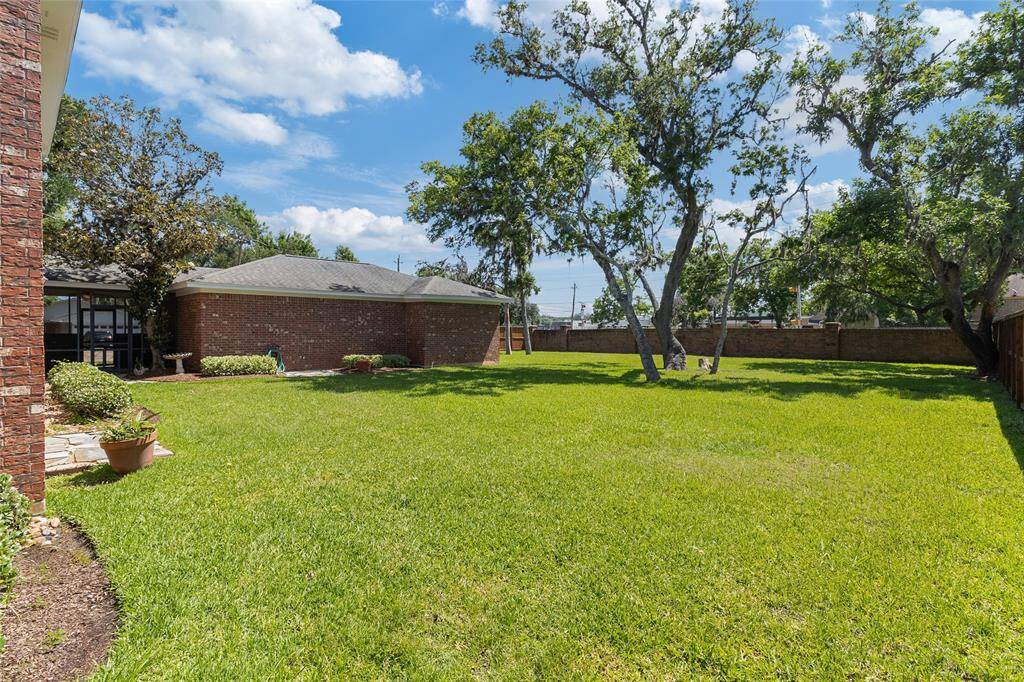 Expansive backyard offers plenty of space to relax or entertain beneath mature trees & includes valuable recent upgrades—a 3-ton RUUD HVAC unit installed in 2022 & a new fan motor was recently installed to ensure year-round comfort & efficiency.