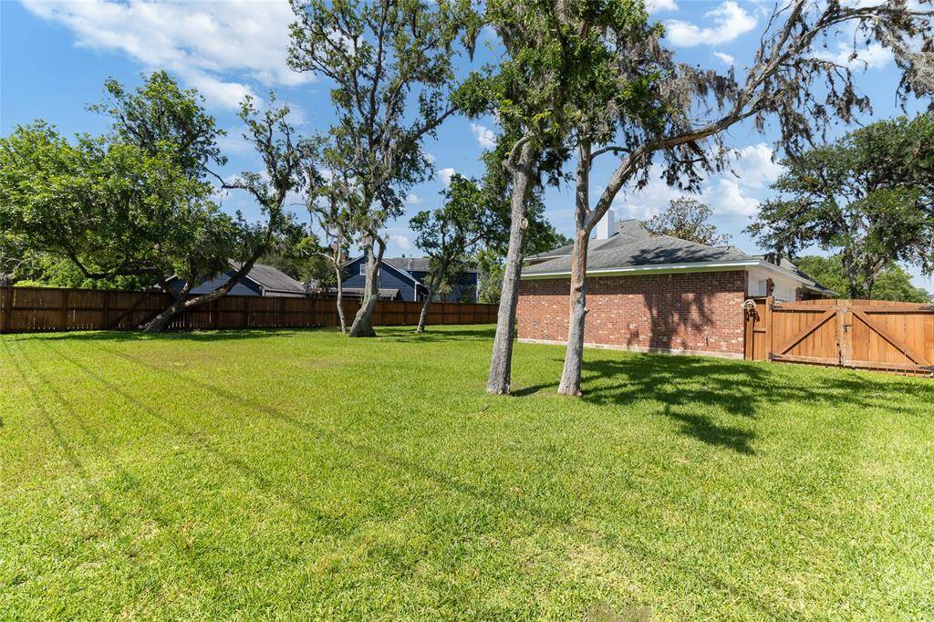 Set on a spacious 0.452-acre lot, this backyard showcases a lush, well-maintained lawn supported by a full sprinkler system & features a double-wide gate—perfect for accommodating large equipment or hosting gatherings with ease.