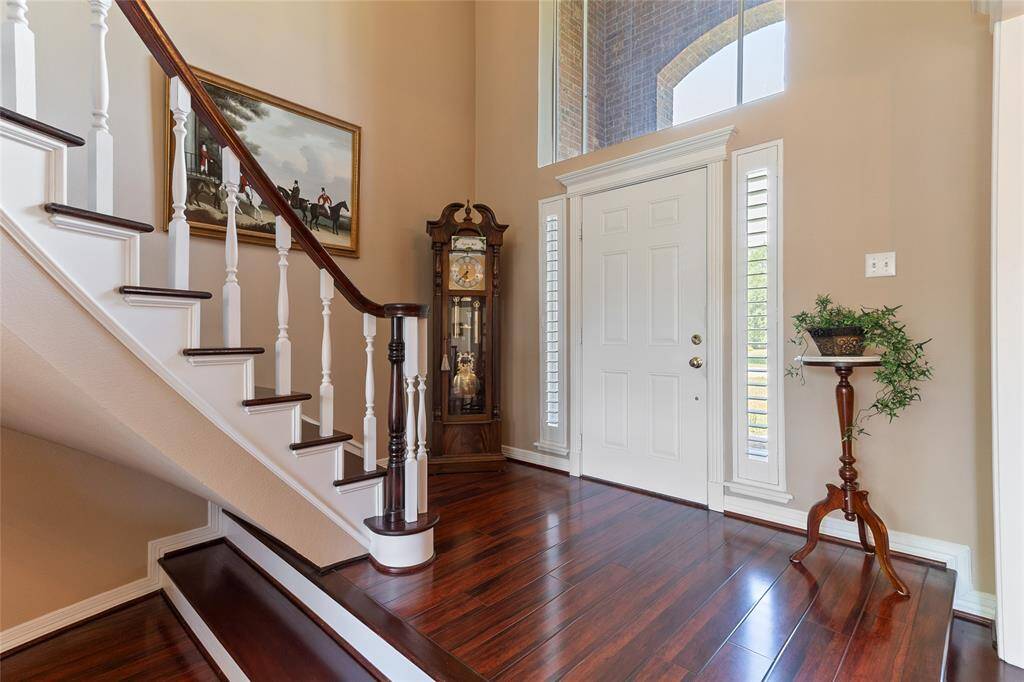 Step into elegance—this elevated foyer welcomes you with rich engineered hardwood floors, soaring ceilings & abundant natural light, setting a grand tone for the rest of the home.