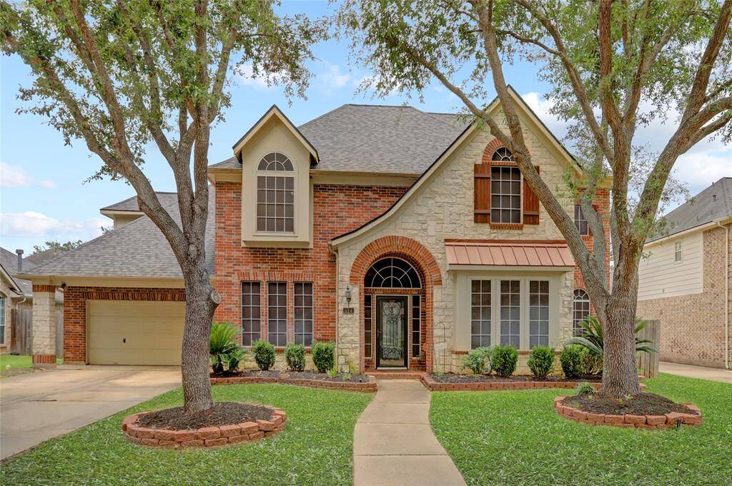 Curb appeal shines with this stately brick exterior, arched entryway, and mature landscaping set on a quiet cul-de-sac in Rivers Edge.