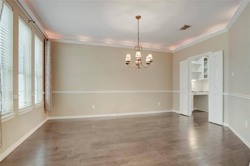 A bright breakfast area with oversized windows brings in natural light and offers backyard views for casual dining.