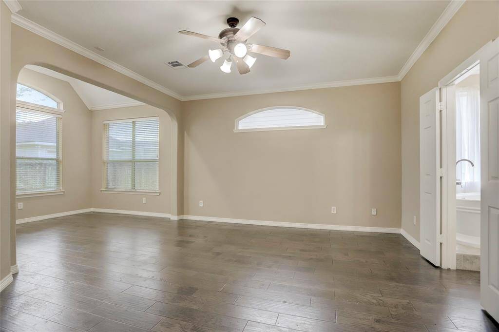 Upstairs, a large game room is perfect for entertaining, with multiple windows bringing in great light.