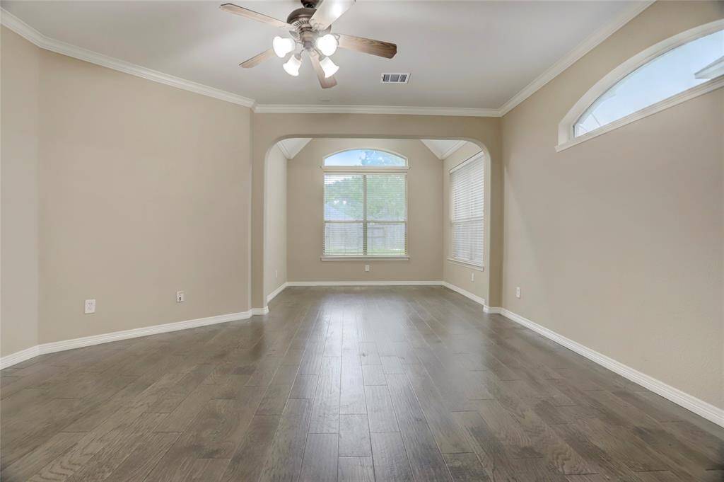 A versatile upstairs room offers potential for a media area, playroom, or additional lounge space.