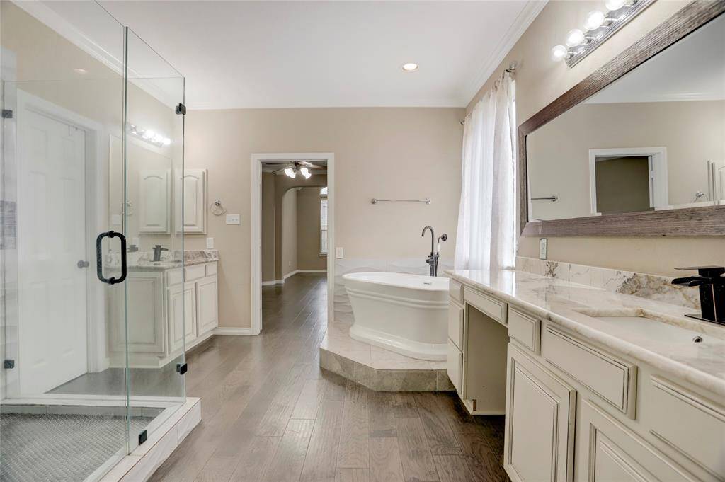 Another angle of the primary bath emphasizes its spacious layout and separate vanities.