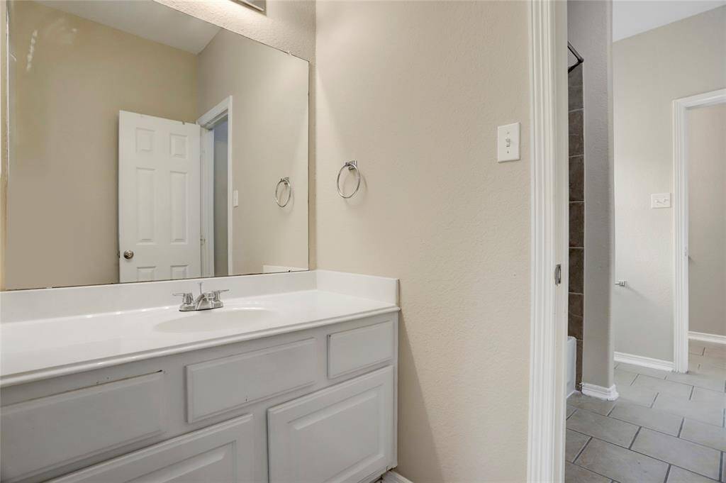 Additional upstairs bath with extended vanity and bright lighting makes morning routines effortless.