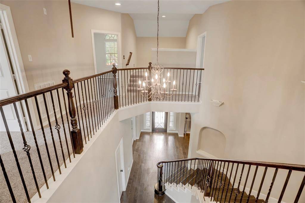 Looking down from the upstairs landing showcases the grand entry and elegant staircase.