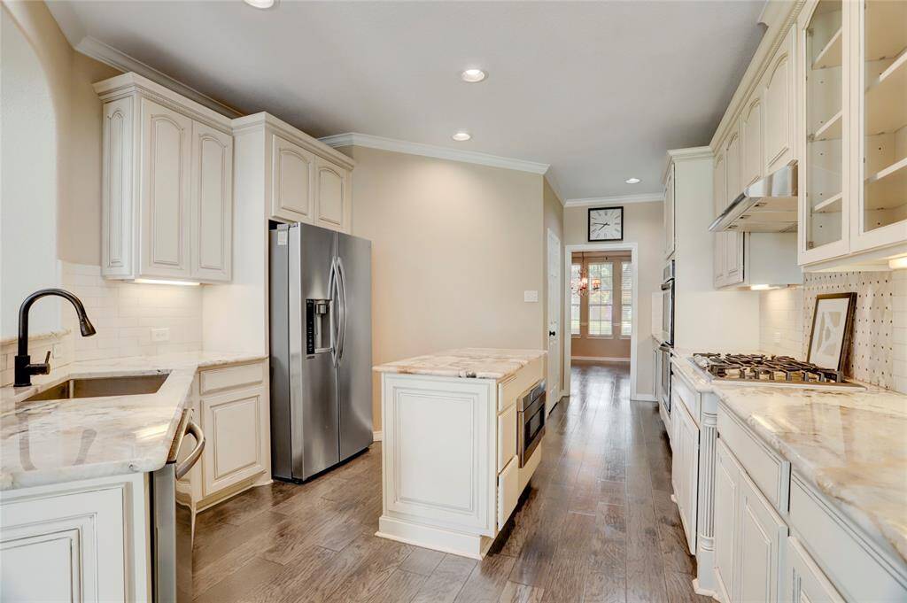 A center island and butler's pantry enhance the kitchen's functionality, while the open layout connects effortlessly to the breakfast area.
