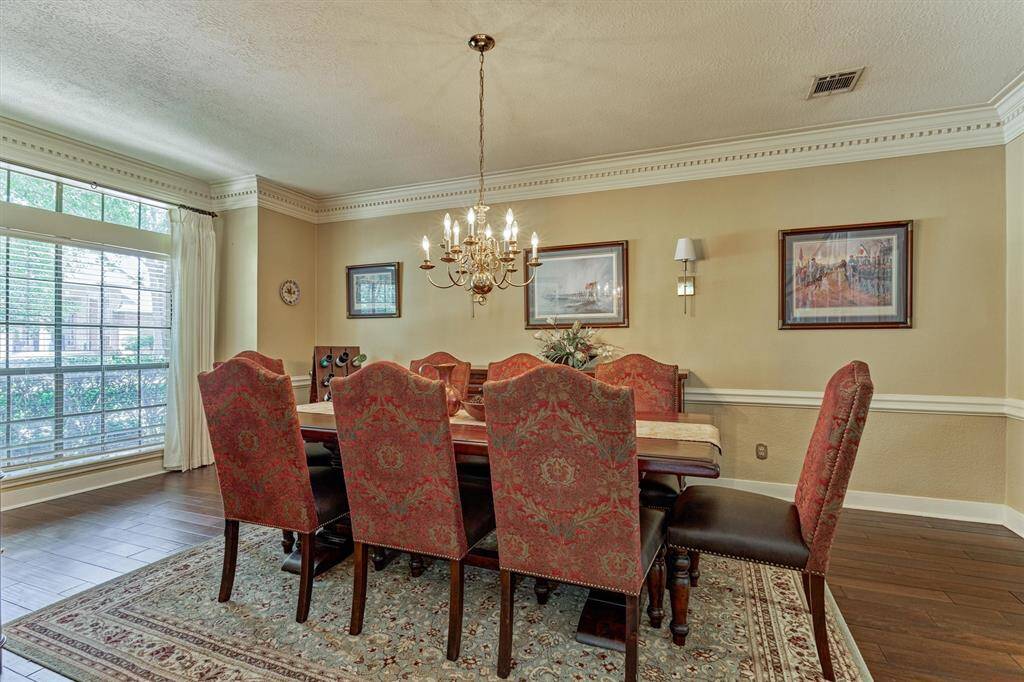 Timeless formal dining space with durable, beautiful flooring and classic architectural details.