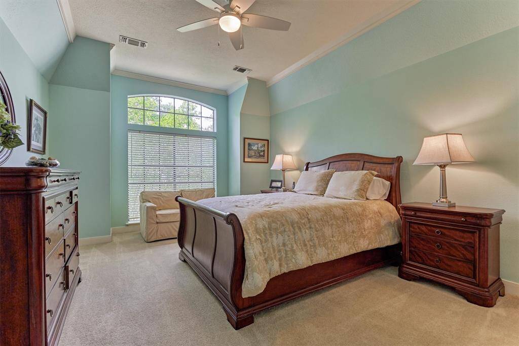 Peaceful upstairs bedroom retreat with vaulted ceilings and natural light, offering comfort and privacy for guests or family.