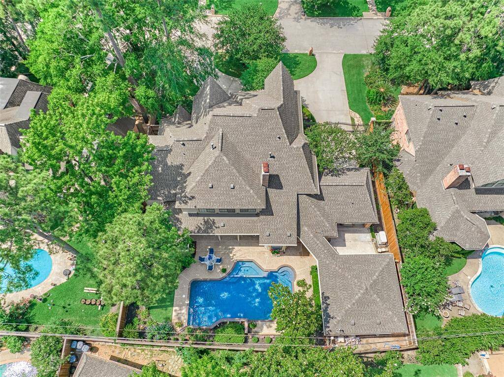 Bird’s-eye view of your private oasis—stunning curb appeal, sparkling pool, and perfectly manicured landscaping all on full display