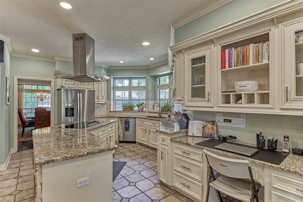 Functional kitchen workstation and extra cabinetry—perfect for a home command center, cookbook storage, or remote work zone.