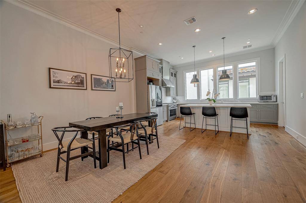 Dining area provides ample space for entertaining under an elegant light fixture.