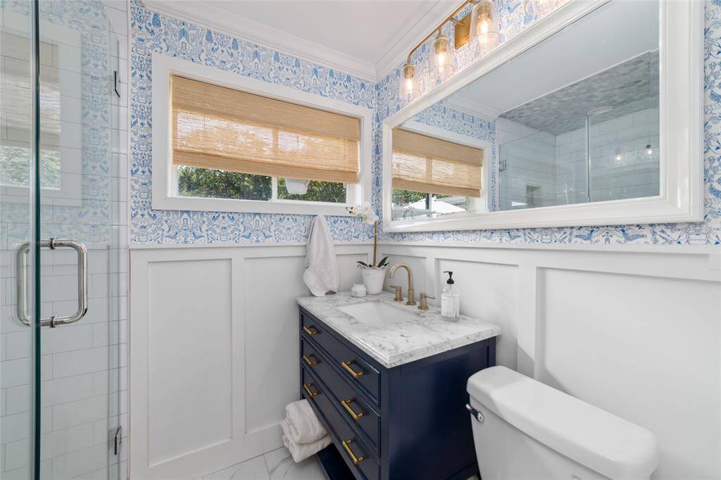 A custom sink vanity, elevated lighting, and standout wallpaper bring style and substance to your morning routine. It’s fresh, functional, and full of personality.