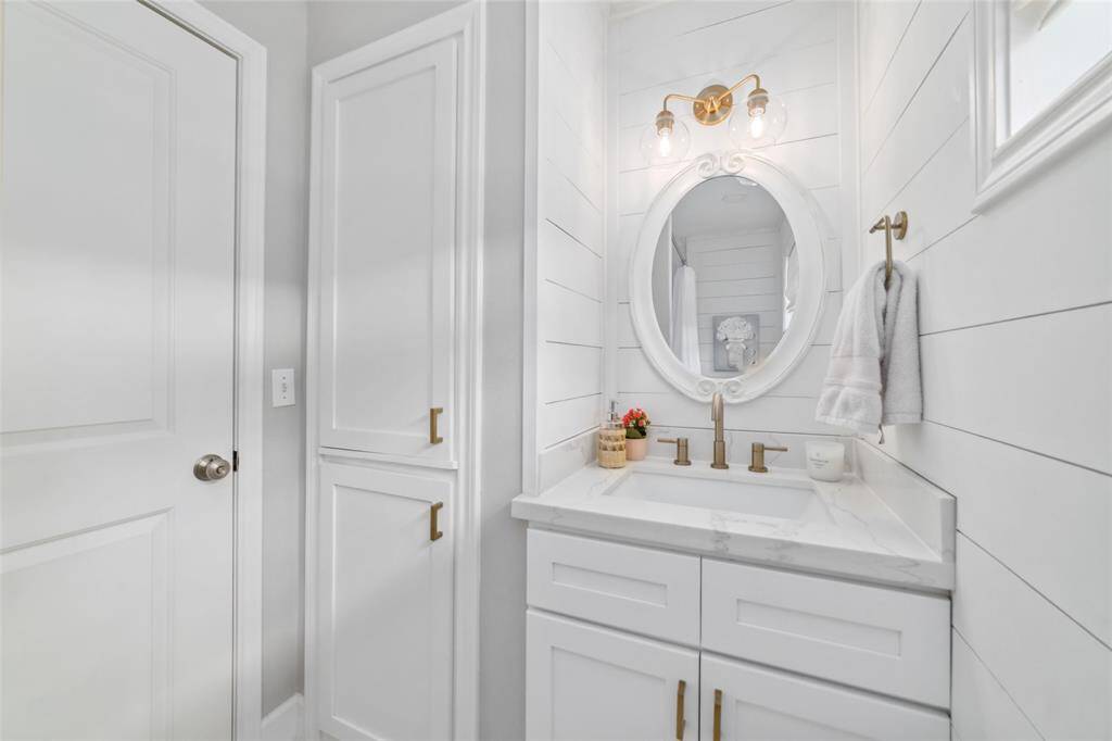 Brass fixtures, bold tile, and a floating mirror make this guest bath feel like something out of a boutique hotel. Your guests won’t forget it, and your selfies will thank you.