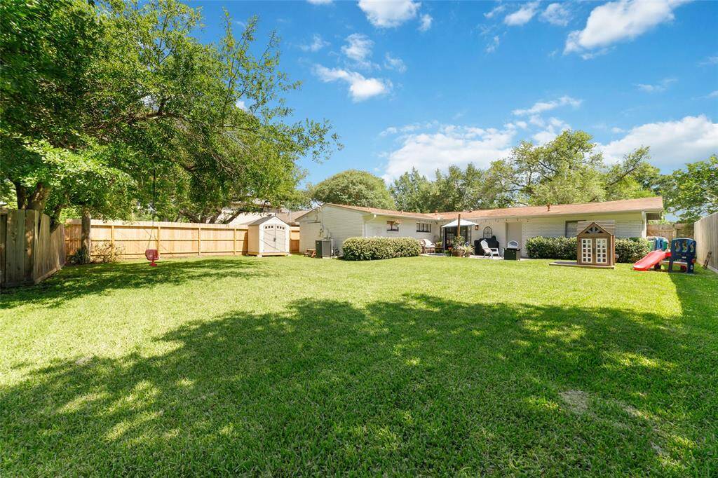 This sprawling backyard is the ultimate blank canvas, perfect for weekend kickball games, garden dreams, or letting the pups run wild. With mature shade trees, and a roomy storage shed, it’s got everything you need to make the most of outdoor living.