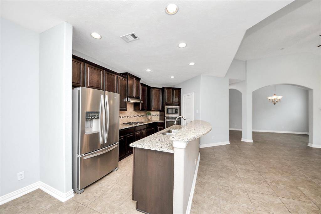 This galley style kitchen has plenty of cabinet and counter space; not shown is the spacious walk-in pantry.