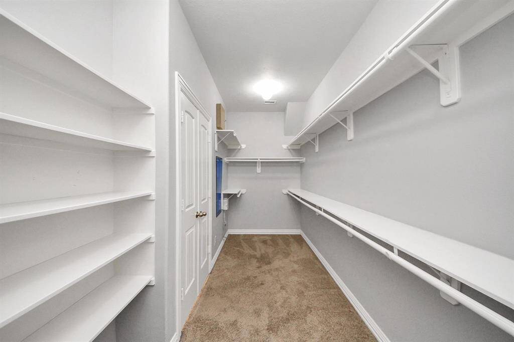 Primary closet is HUGE! There's plenty of space for accessory items in addition to your clothes.