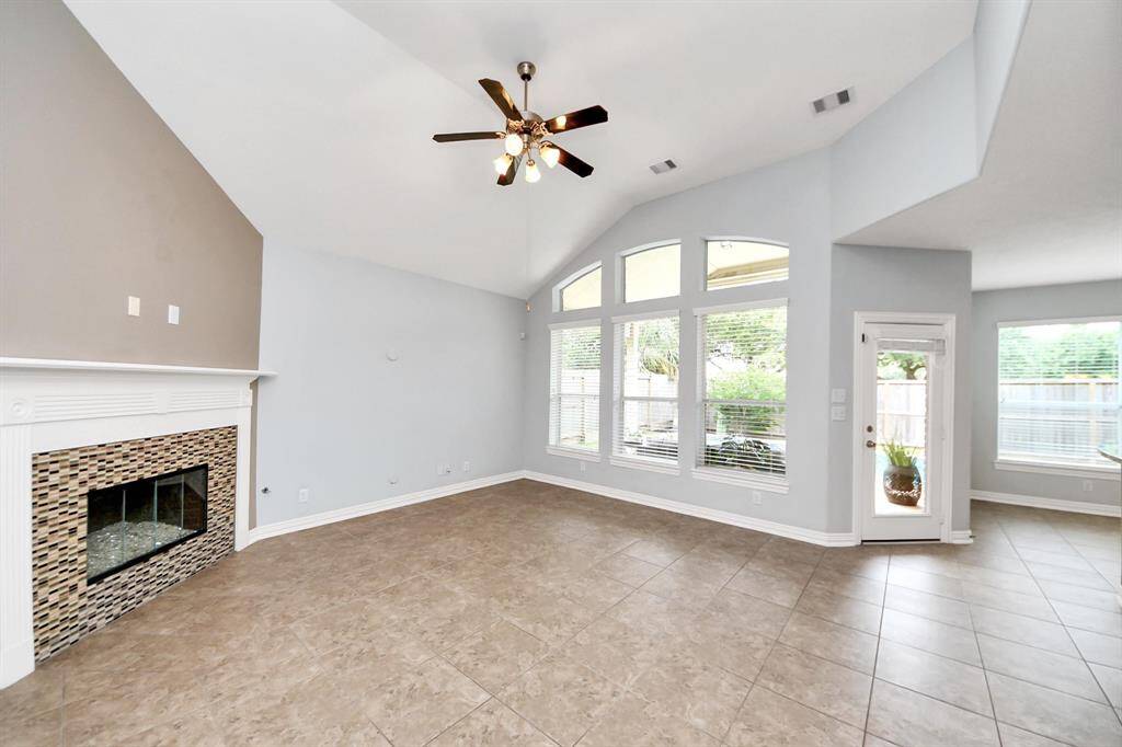 Lovely gas fireplace with updated tiles is the focal point of the family room. Your TV could be mounted above the fireplace or on the large wall next to it.