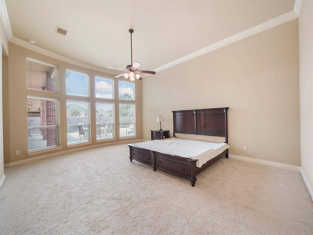 Indulge in the ultimate retreat within this home's luxurious primary bedroom. A breathtaking curved wall of windows floods the space with natural light, creating a serene and inviting atmosphere. Enjoy the convenience of two spacious walk-in closets and unwind in the spa-like ensuite, designed for pure relaxation.