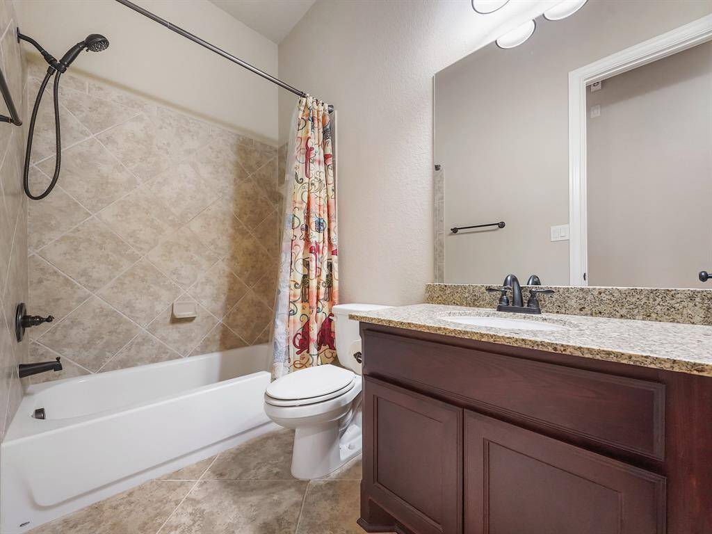 Conveniently located near the secondary bedrooms, this well-appointed bathroom offers ease of access for family and guests.
