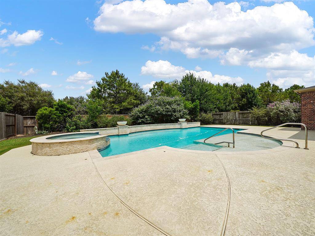 Indulge in resort-style living with this property's sparkling heated pool and spa. Highlights include a sun shelf for relaxation and an elegant curved wall feature. Mature landscaping completes this private, backyard paradise.