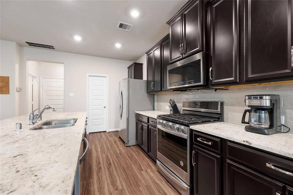 The doors at the other end of the kitchen lead to an amazing walk-in pantry. Great storage solutions in this house!