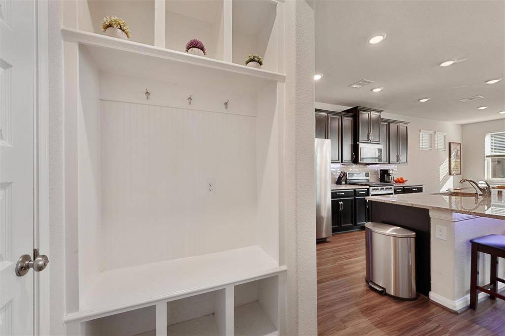 This drop space is ideally located off the garage and is the perfect place to store all your things.
