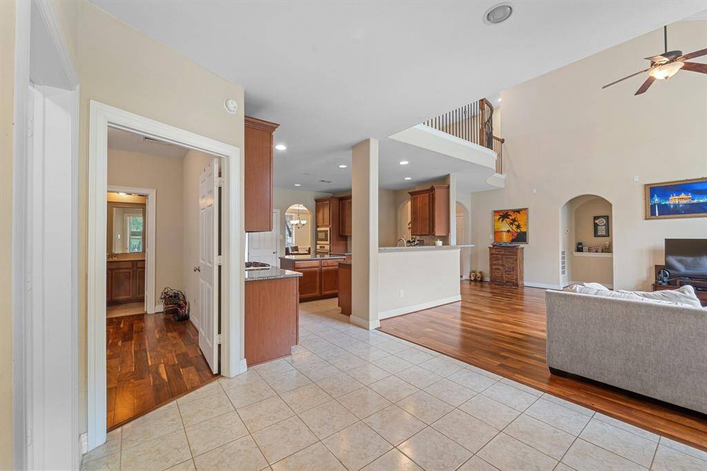 Spacious open-concept kitchen connects seamlessly to the breakfast area and living room, featuring granite countertops and a functional layout.