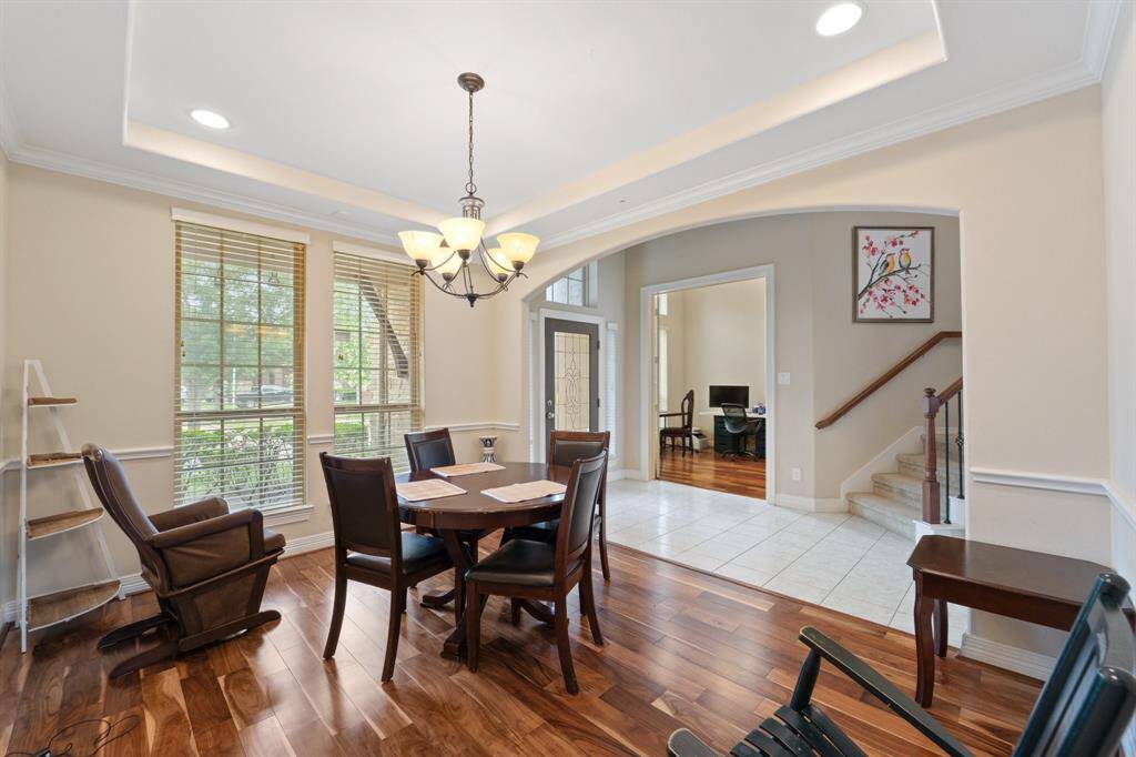 Enjoy effortless flow from the formal dining room to the foyer and study, enhanced by wide windows and hardwood flooring.