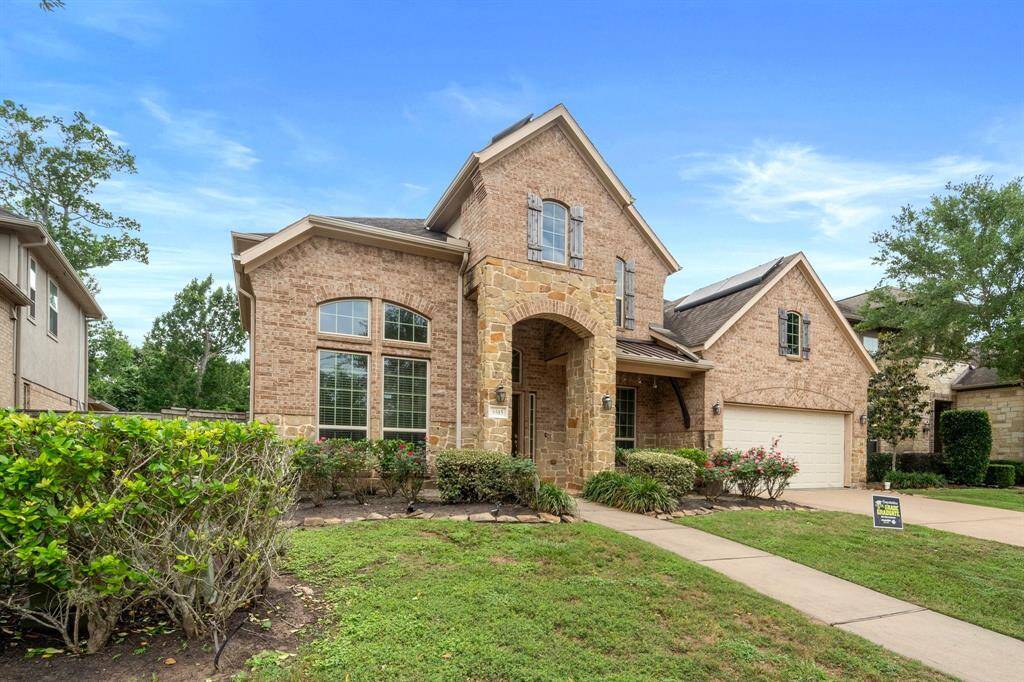 A professional landscape design and arched stone entry set a grand tone as you approach this inviting home from the sidewalk.