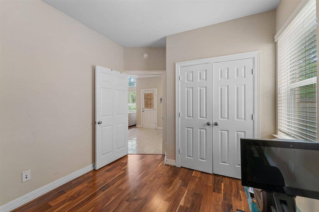 A double-door closet and neutral tones make this space perfect for guests, a home gym, or a private office.