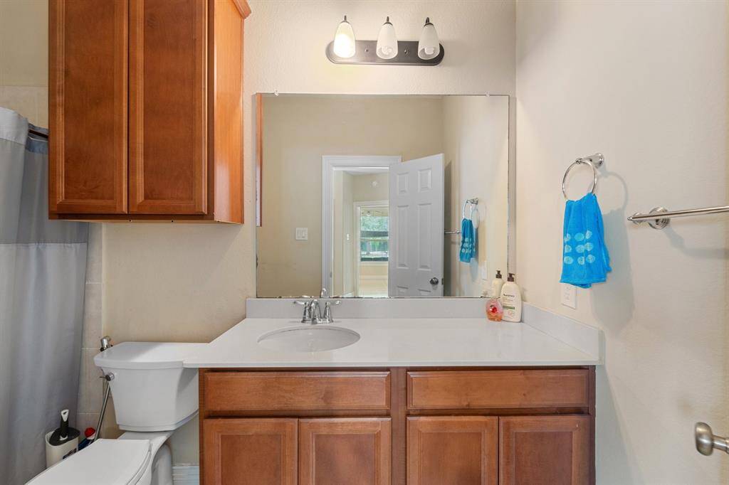 The full bath includes an extended vanity, updated lighting, and a shower/tub combo—perfect for guests or multi-generational living.