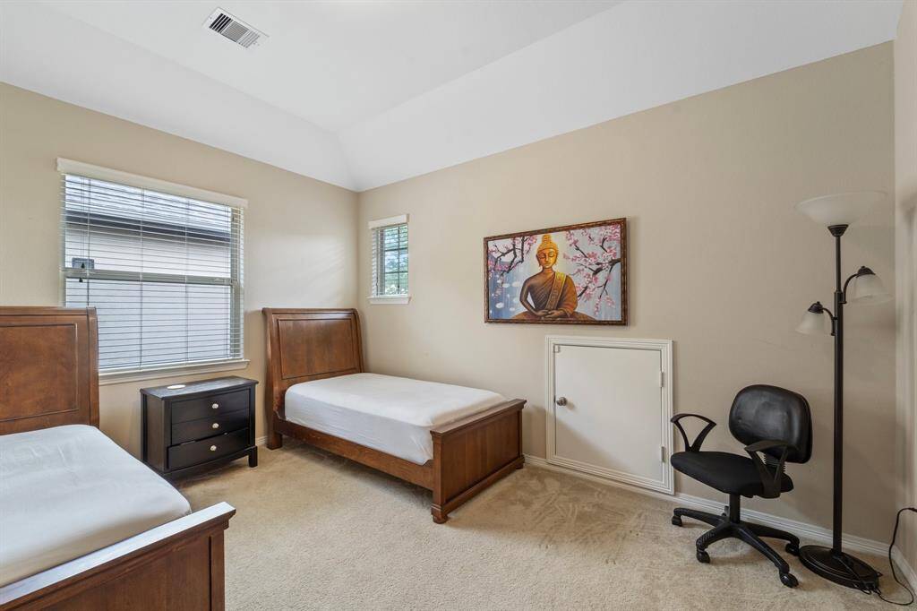 Dual windows and private attic access make this a flexible and well-lit space.