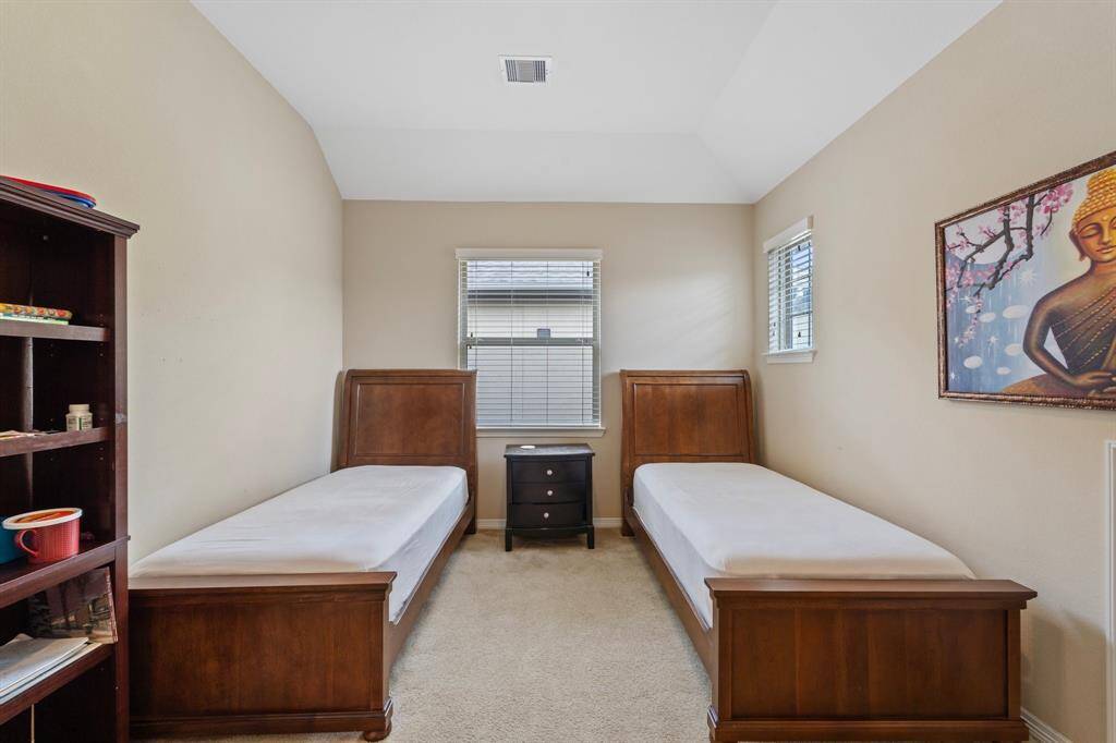 The serene secondary bedroom easily fits two beds and furniture with room to spare.
