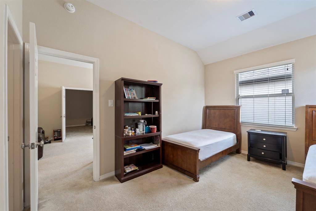 Glimpse into the adjacent media or game room, highlighting ideal upstairs flow.