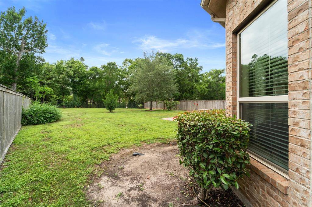Expansive side yard offers plenty of room for play, gardening, or future landscaping projects.