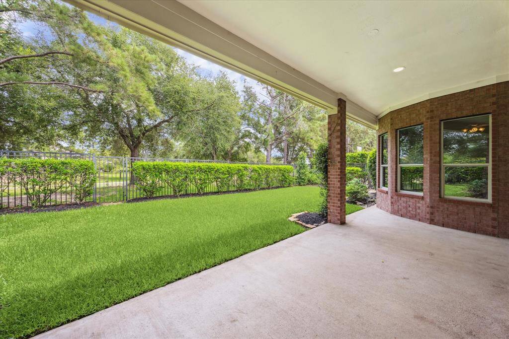 Covered backyard patio accessible from the family room, offering a shaded outdoor space with no rear neighbors.