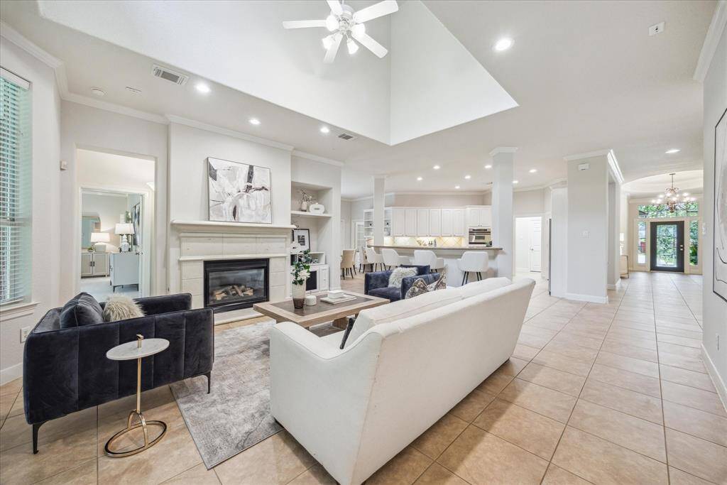 The expansive family room features fresh interior paint, soaring ceilings, and a central fireplace.